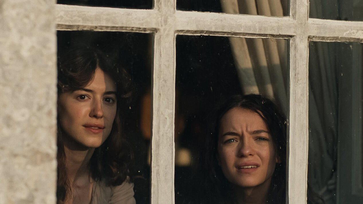 Elinor & Marianne at a window, Sense & Sensibility 2026 film courtesy of Focus Features Movie still of Elinor and Marianne looking out a window, from Focus Features film version of *Sense & Sensibility*