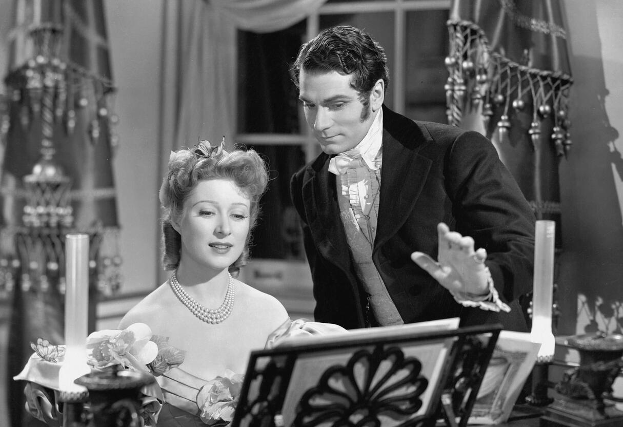 Photograph of a Jane Austen action figurine with bendable arms, a quill pen and a writing desk Photograph of a Jane Austen action figurine with bendable arms, a quill pen and a writing desk